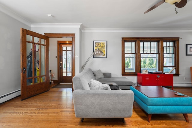 living room with baseboard heating, ceiling fan, ornamental molding, and wood finished floors