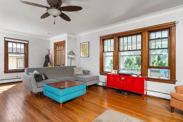 living area featuring crown molding, a baseboard radiator, ceiling fan, and hardwood / wood-style flooring