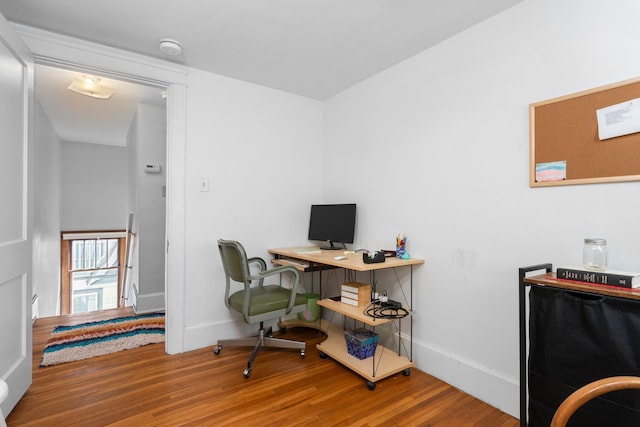 office area with baseboards and wood finished floors