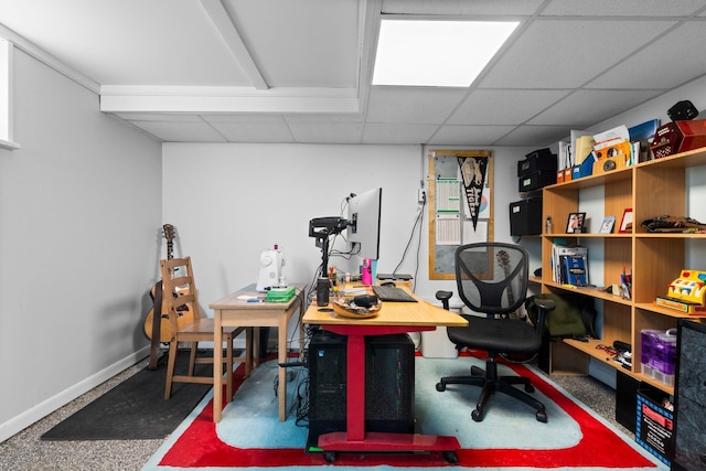 game room with baseboards and a drop ceiling