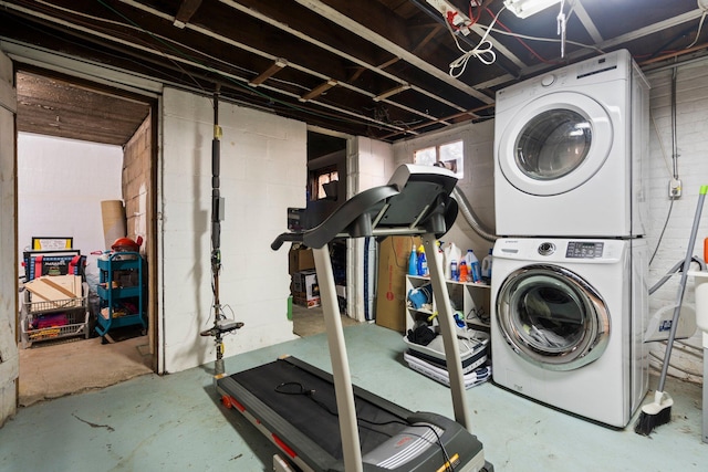 interior space with laundry area and stacked washer and clothes dryer