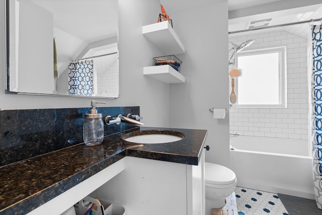 bathroom with vanity, tile patterned flooring, lofted ceiling, toilet, and shower / tub combo