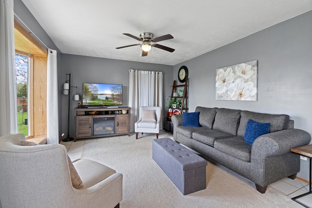 living area with plenty of natural light, ceiling fan, and light colored carpet