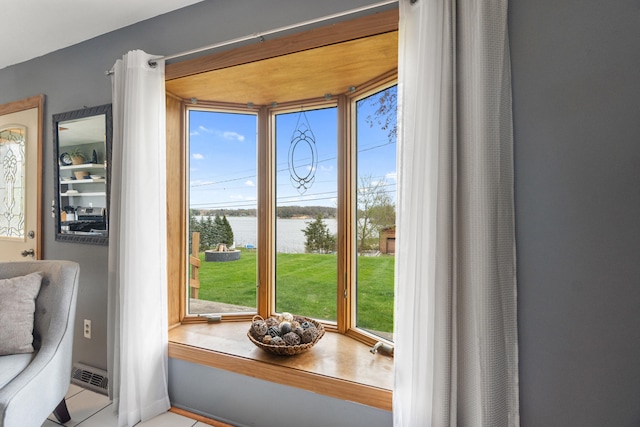 doorway with a healthy amount of sunlight and a water view