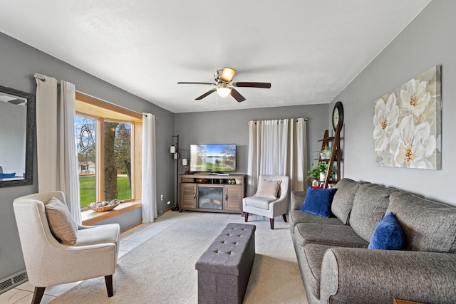living room featuring light tile patterned floors, baseboards, and ceiling fan