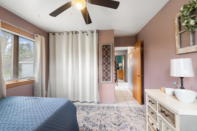 bedroom with ceiling fan and light tile patterned floors