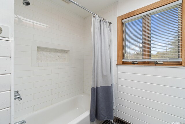 bathroom with shower / bath combo with shower curtain