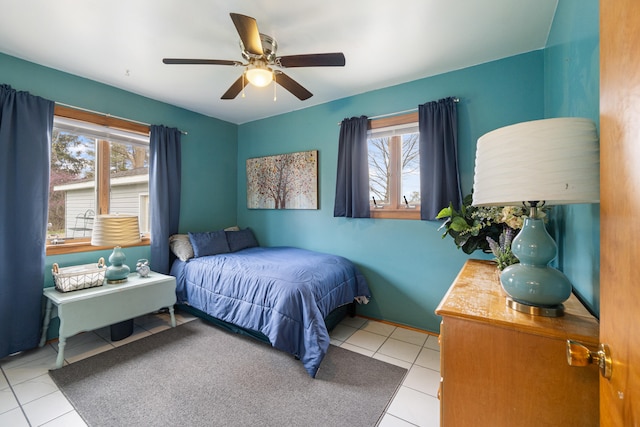 tiled bedroom with a ceiling fan