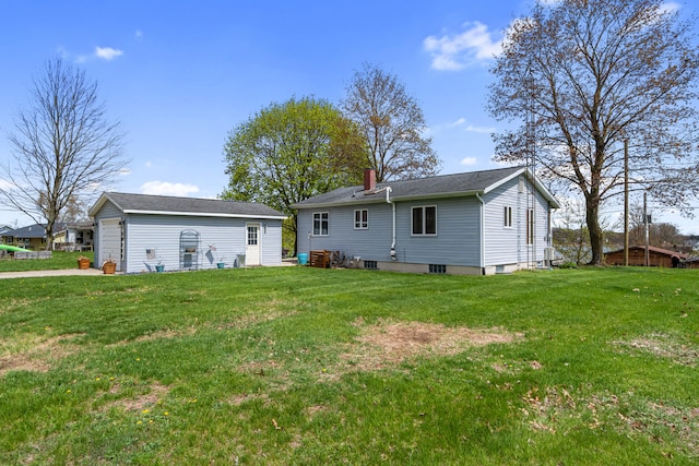 back of property featuring a yard, an outbuilding, and a chimney