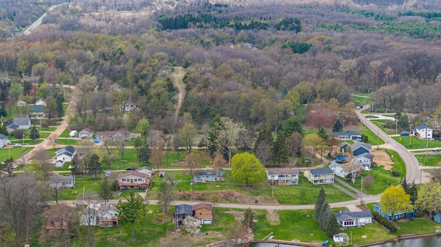 drone / aerial view with a residential view and a wooded view