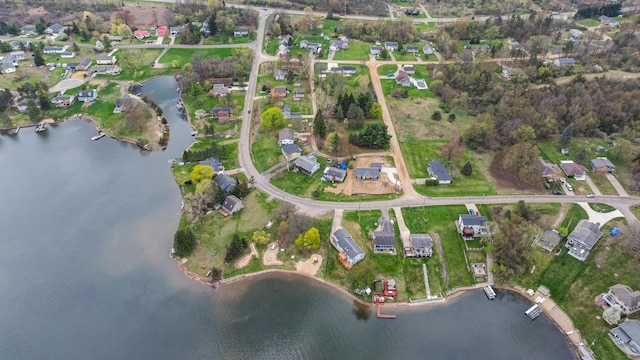 drone / aerial view featuring a residential view and a water view