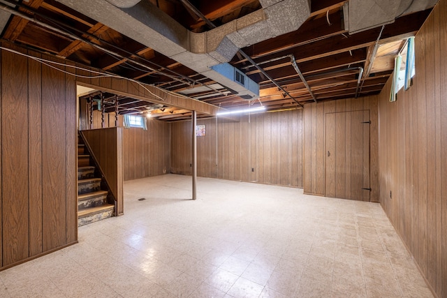 19302 Moross Rd, Detroit, MI 48224 - basement with tile patterned floors, stairway, and wooden walls