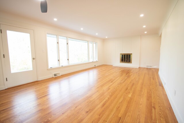 unfurnished living room featuring recessed lighting, baseboards, visible vents, and light wood-style floors