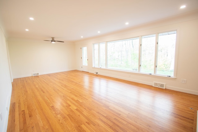 unfurnished room with baseboards, visible vents, and a wealth of natural light