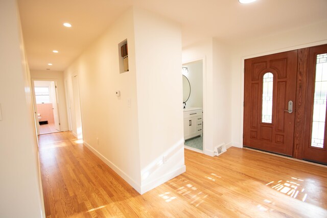 foyer entrance featuring recessed lighting, baseboards, visible vents, and light wood-style floors