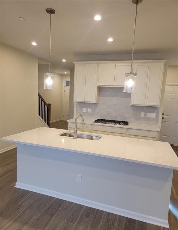 kitchen featuring backsplash, a sink, white cabinets, dark wood-style floors, and recessed lighting