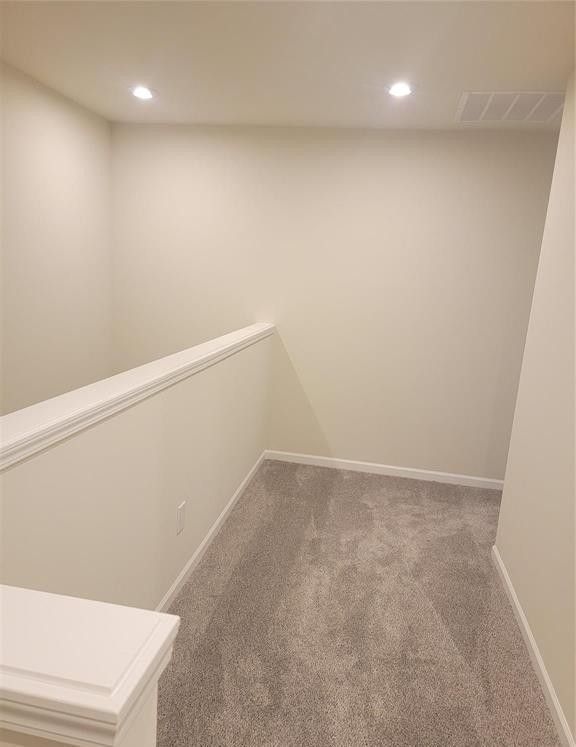 interior space with carpet floors, recessed lighting, and visible vents