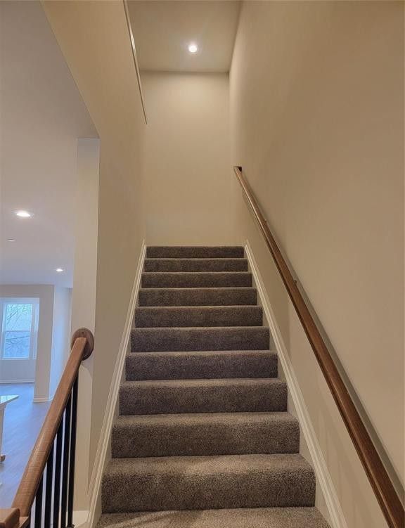 staircase with recessed lighting