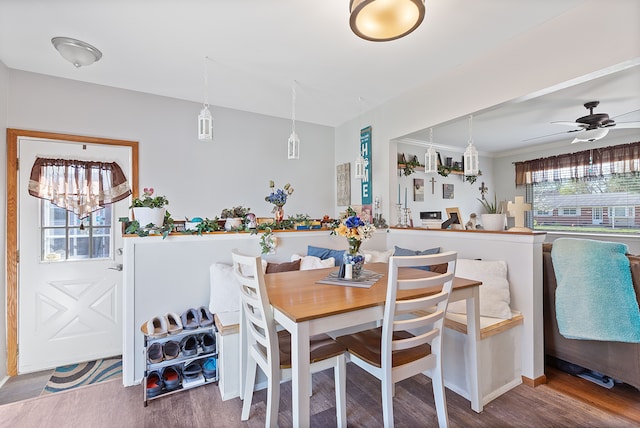 dining space with ceiling fan and wood finished floors