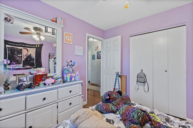 bedroom with baseboards, a closet, and wood finished floors