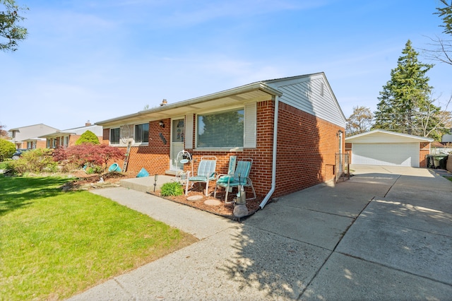 view of front of property featuring brick siding, an outdoor structure, a front yard, and a garage