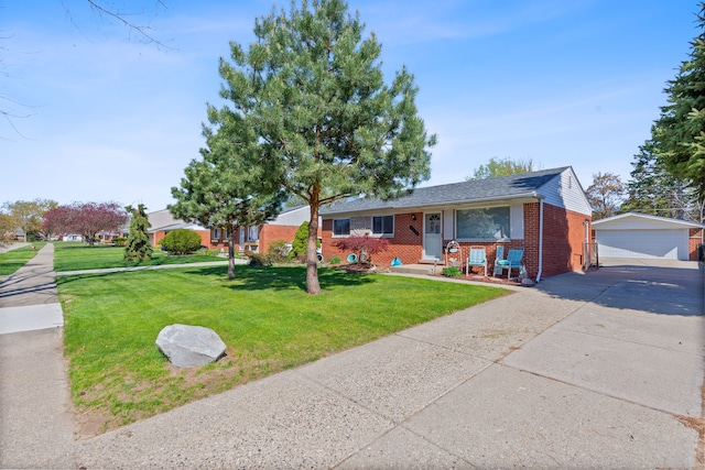 view of front of home with brick siding, a garage, an outbuilding, and a front lawn