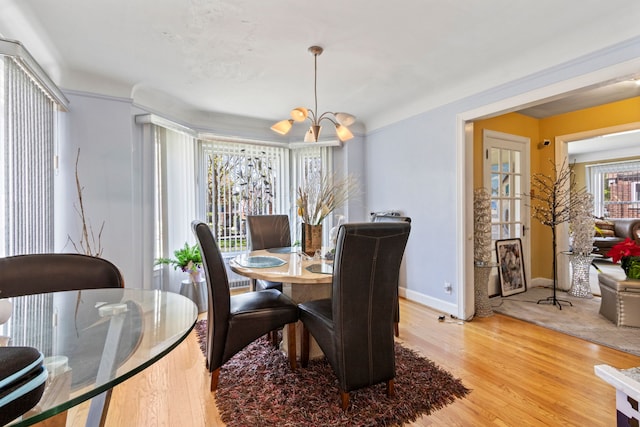14174 Archdale St, Detroit, MI 48227 - dining area with an inviting chandelier, baseboards, and light wood-type flooring