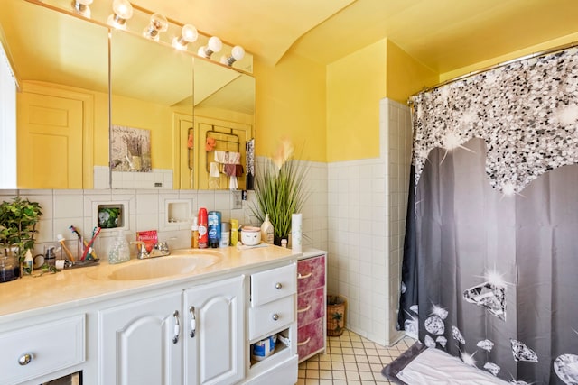 14174 Archdale St, Detroit, MI 48227 - full bathroom with wainscoting, tile patterned flooring, vanity, tile walls, and a shower with curtain