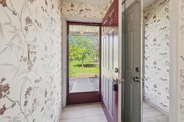 entryway with wallpapered walls