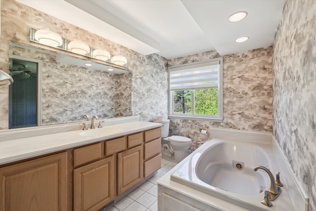 full bath with tile patterned flooring, a tub with jets, vanity, toilet, and wallpapered walls