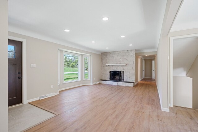 unfurnished living room with recessed lighting, visible vents, a wealth of natural light, and light wood-style floors