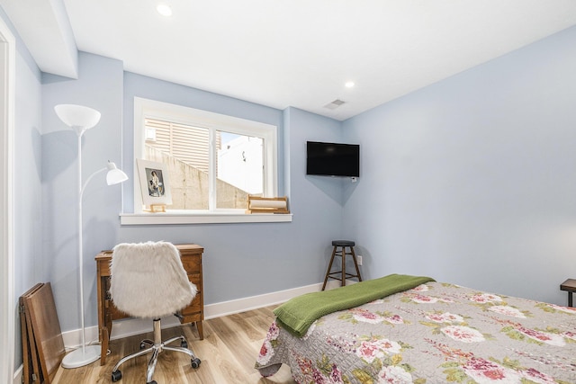 bedroom featuring baseboards, recessed lighting, wood finished floors, and visible vents