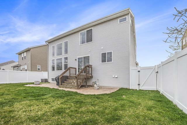 back of property featuring a lawn, a fenced backyard, a gate, and a patio area