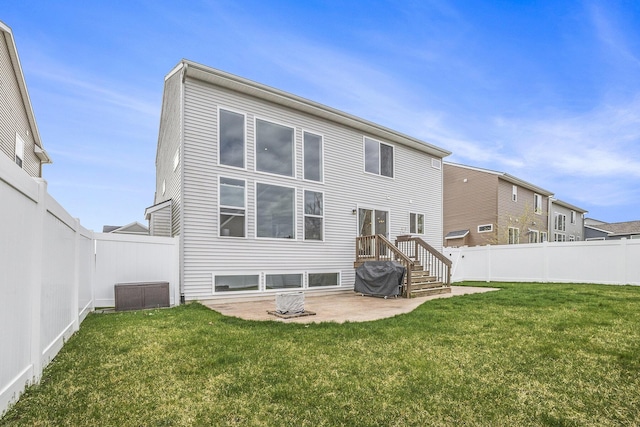 rear view of property with a yard, a patio, and a fenced backyard