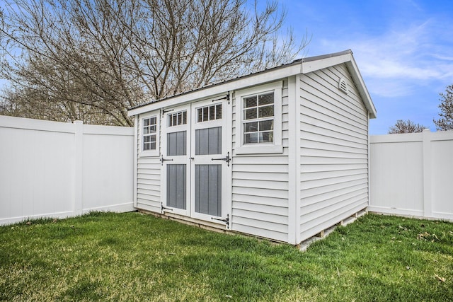 view of shed with a fenced backyard