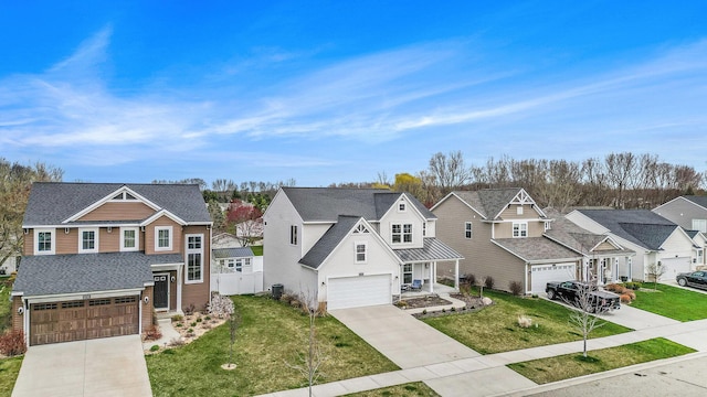 view of front facade featuring a garage, a front lawn, driveway, and a residential view