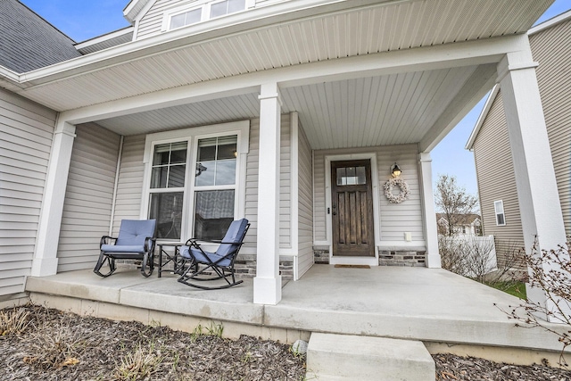 view of exterior entry with a porch