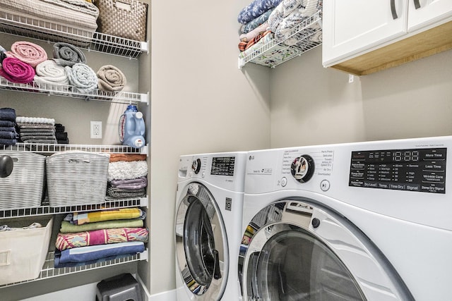 laundry area with cabinet space and washer and clothes dryer