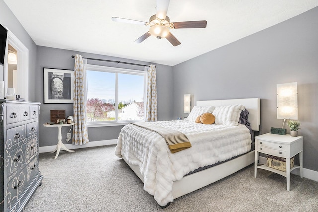carpeted bedroom featuring baseboards and a ceiling fan