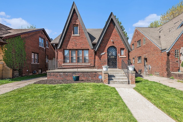5279 E Somerset Ave, Detroit, MI 48224 - english style home featuring a front lawn, brick siding, and roof with shingles