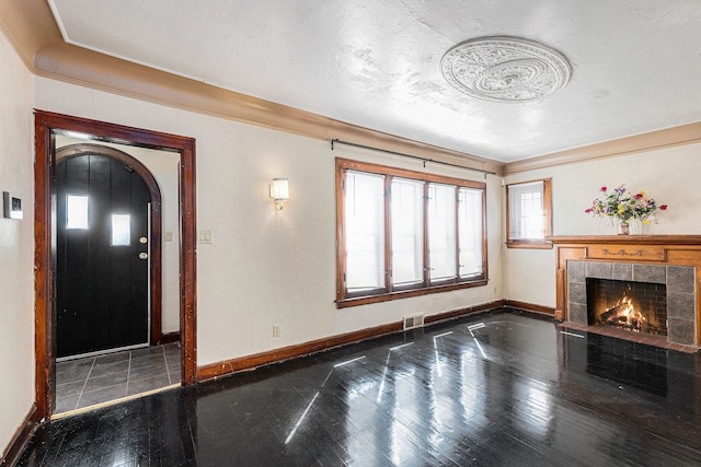 5279 E Somerset Ave, Detroit, MI 48224 - unfurnished living room featuring baseboards, a fireplace, arched walkways, and ornamental molding