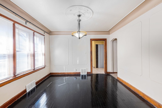 5279 E Somerset Ave, Detroit, MI 48224 - unfurnished dining area featuring arched walkways, baseboards, and wood finished floors