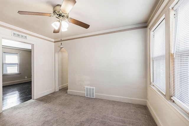 5279 E Somerset Ave, Detroit, MI 48224 - empty room with carpet floors, a ceiling fan, ornamental molding, baseboards, and arched walkways