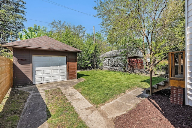 5279 E Somerset Ave, Detroit, MI 48224 - view of yard featuring an outbuilding, concrete driveway, and a detached garage