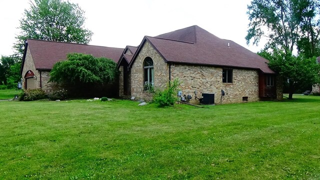 7407 Beecher Rd, Flint, MI 48532 - view of property exterior with a lawn and brick siding