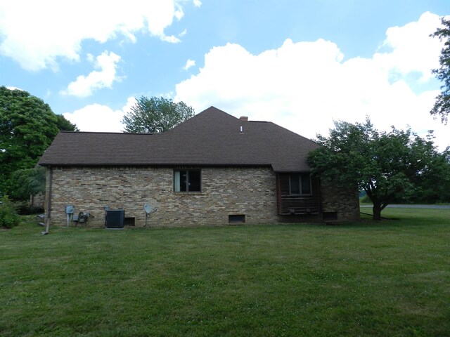7407 Beecher Rd, Flint, MI 48532 - view of property exterior with a yard, brick siding, and roof with shingles
