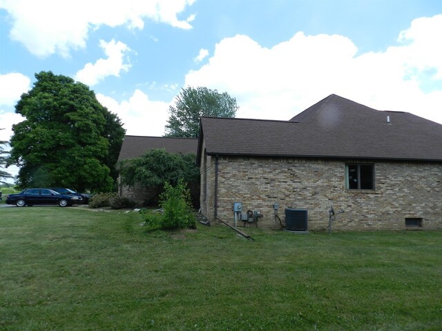 7407 Beecher Rd, Flint, MI 48532 - view of side of property featuring brick siding, a yard, and a shingled roof