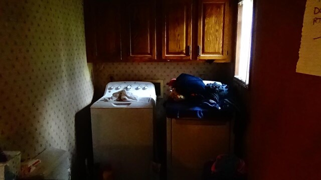 7407 Beecher Rd, Flint, MI 48532 - washroom with washer / clothes dryer, wallpapered walls, and cabinet space