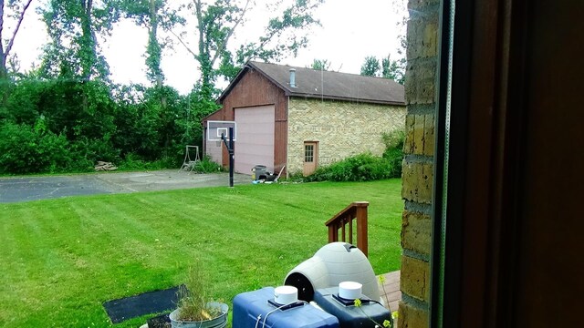 7407 Beecher Rd, Flint, MI 48532 - view of grassy yard with an outdoor structure and a detached garage