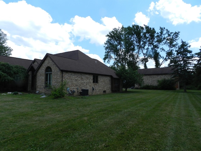 7407 Beecher Rd, Flint, MI 48532 - view of property exterior featuring stone siding and a lawn
